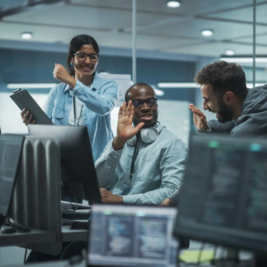 Diverse Group of Professionals Celebrate Success in Modern Office Brainstorming It Programmers Use Computer Talk High five over Finding Brilliant Solution Software Engineers Develop Innovative App